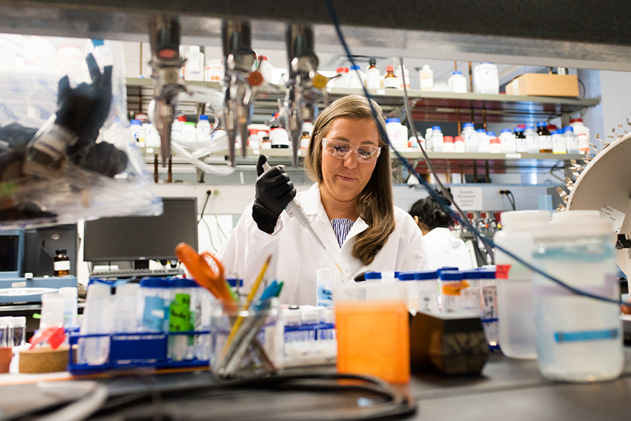 Ph.D. candidate Angela Wagner uses a pipette inside a biomedical engineering lab.