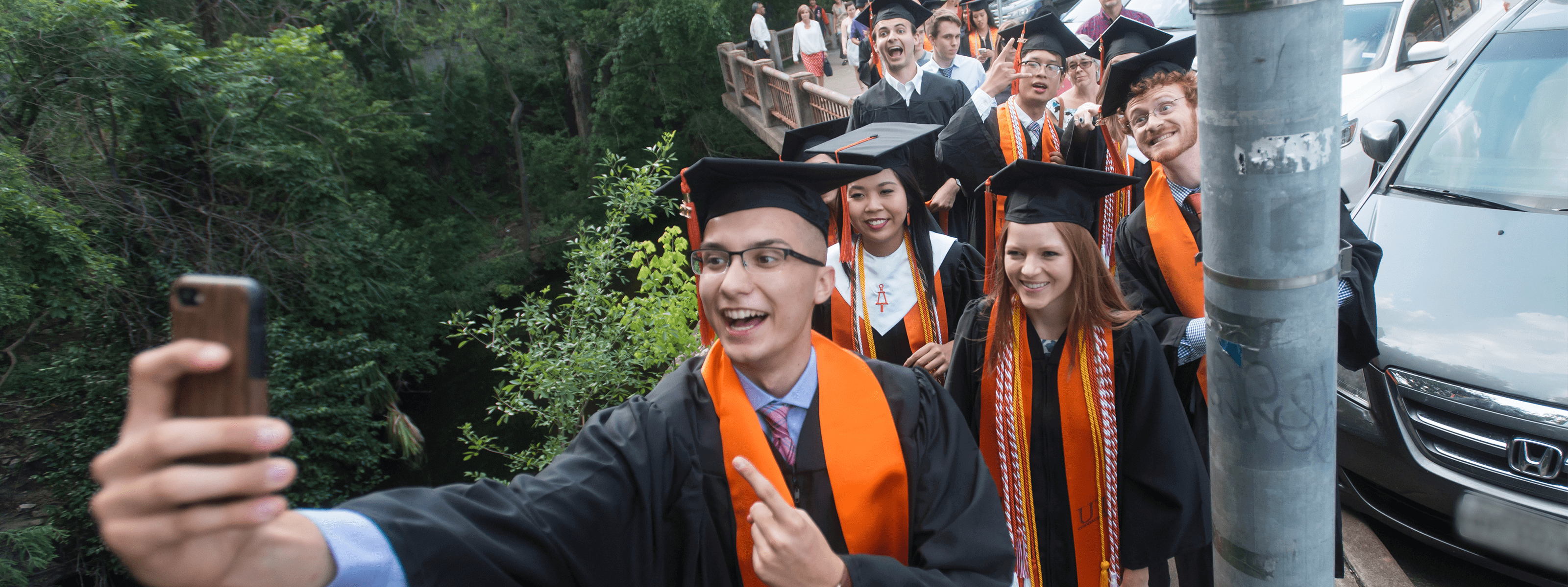 crowd of graduating students wearing Cockrell School of Engineering regalia posing for a selfie