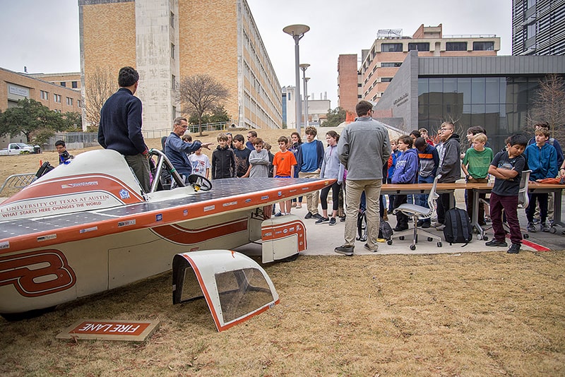Children look at a solar car built by UT engineering students during the an Edison Lecture event