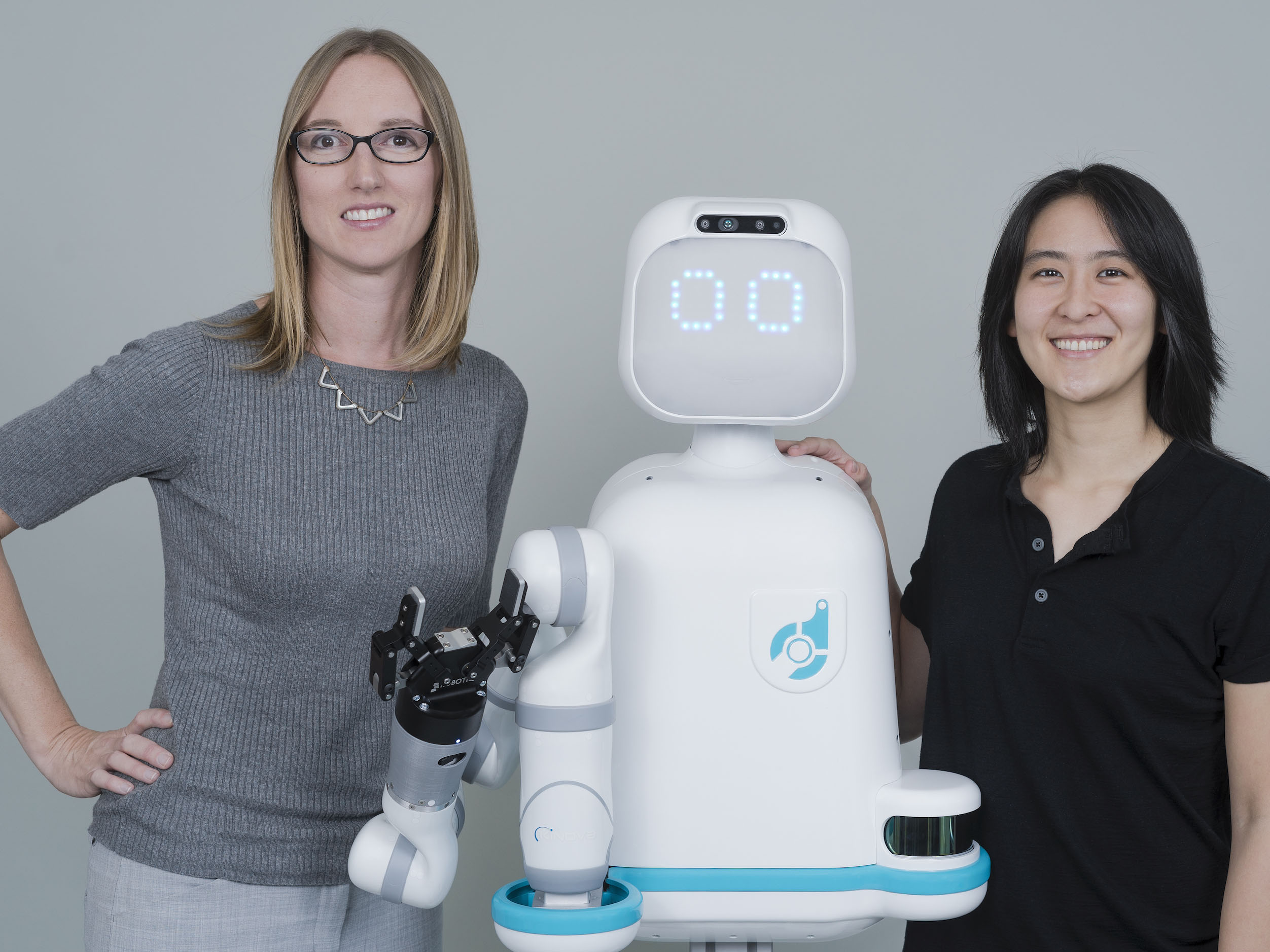 Texas engineer Andrea Thomas and another researcher with their robot Moxi