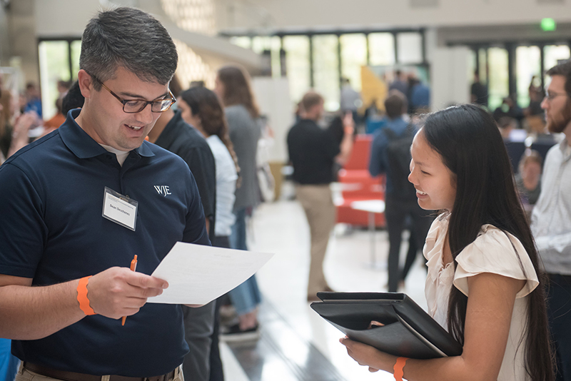Texas engineering student speaking with recruiter at Cockrell School of Engineering recruitment event