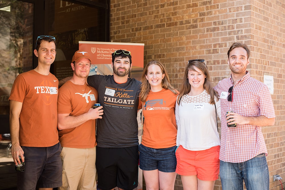 Cockrell School of Engineering alumni wearing UT Austin colors at tailgate event