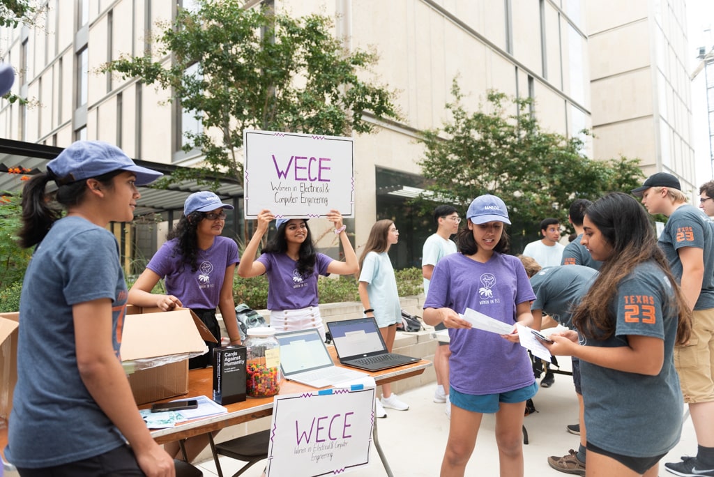 Students from WECE speak with an incoming student while tabling at Gone to Engineering