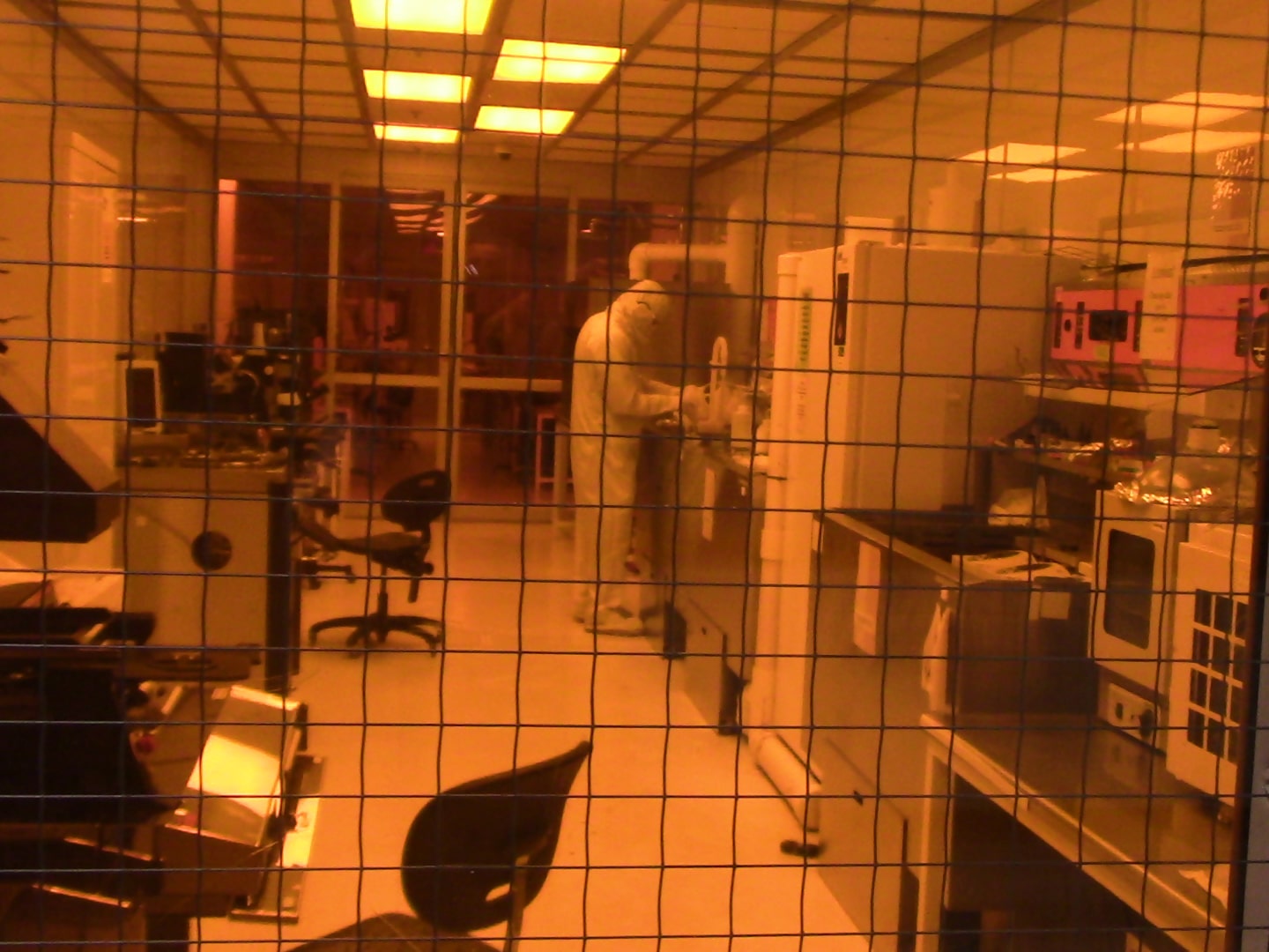 nantech clean room lab space with a researcher working viewed through a window