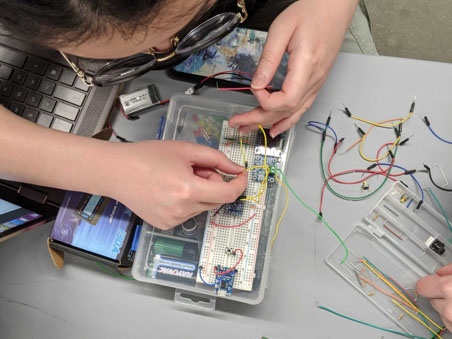 Cockrell student working with wires of various colors